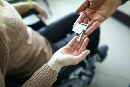 Person with SDA funding getting the keys to her new home placed in her palm. 