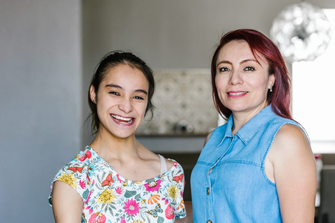 teenage girl with cerebral palsy and her mother at home
