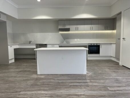 Accessible Logan, open plan kitchen with adjustable table