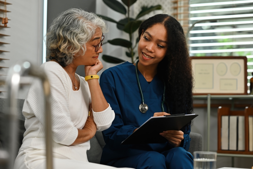 A nurse with a patient, they are doing a I-can assessment.